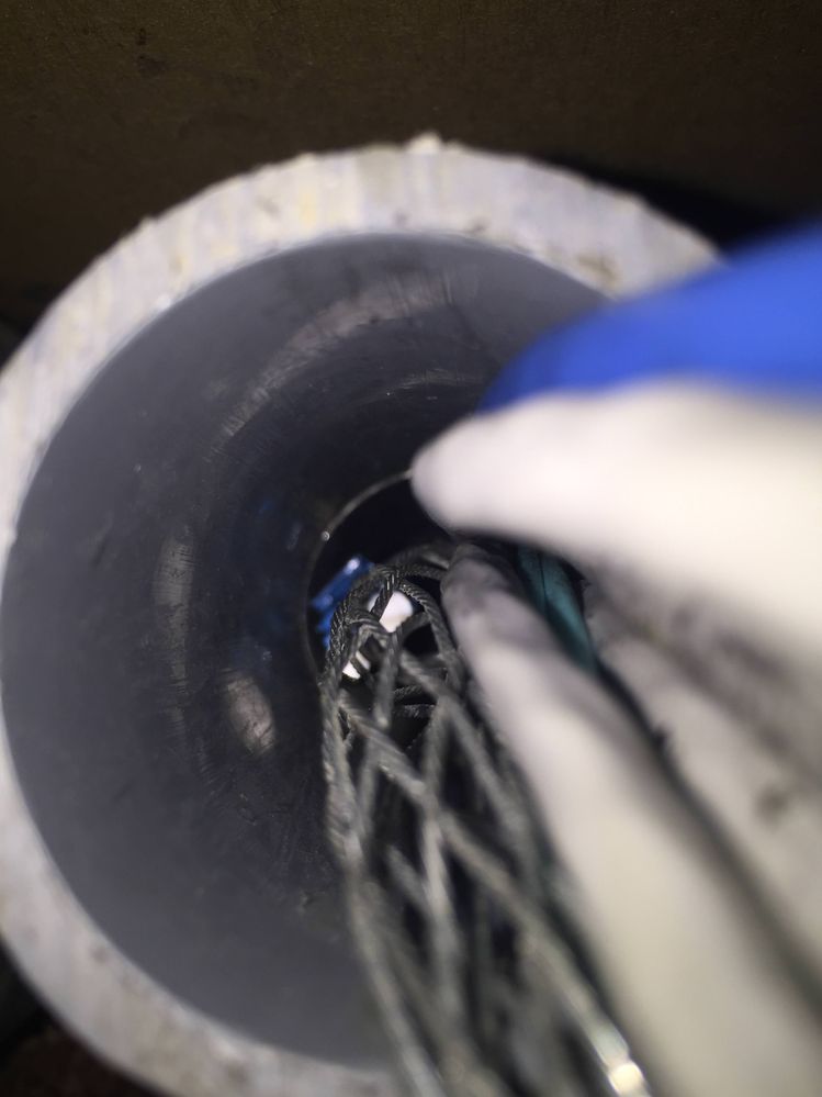 Fiber came loose out of the Chinese finger trap right at the last 3 inches of conduit! Got it out eventually.
